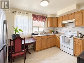 Toronto (Oakridge) triplex for rent - A kitchen with wooden cabinets and a red chair.