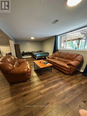 Barrie (Allandale Heights) apartment for rent - A living room with a brown leather couch and a coffee table.