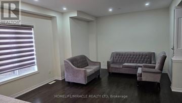 Brampton (Northwest Brampton) apartment for rent - A living room with a grey couch and two armchairs.