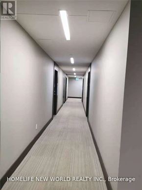 Toronto (Mount Pleasant West) condo for rent - A long hallway with a sign that says "HOMELIFE NEW WORLD REALTY INC., Brokerage".
