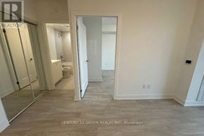 Oshawa (Windfields) condo for rent - A spacious room with a walk-in closet and a doorway leading to another room.