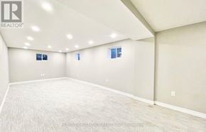 Toronto (Agincourt South-Malvern West) apartment for rent - A spacious room with a carpeted floor and a ceiling with recessed lighting.