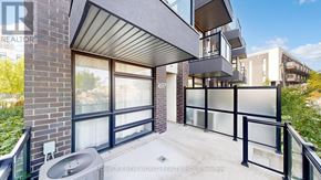 Markham (Wismer) townhouse for rent - A balcony of a building with a glass railing and a brick wall.