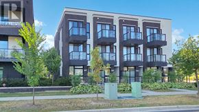 Markham (Wismer) townhouse for rent - A modern apartment building with balconies and a green trash can in front.