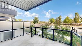 Markham (Wismer) townhouse for rent - A balcony with a railing and a view of trees and a building in the distance.