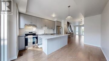 Markham (Wismer) townhouse for rent - A modern kitchen with a large island and stainless steel appliances.