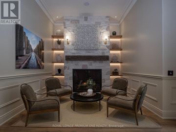 Toronto (Kingsway South) condo for rent - A living room with a fireplace and a painting on the wall.