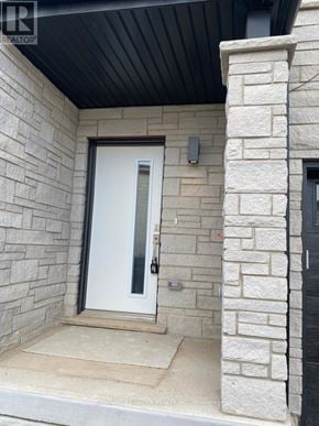 Cambridge townhouse for rent - A white door is on the left side of a black door.
