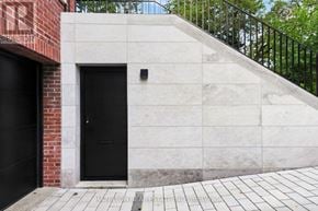 Toronto (Rosedale-Moore Park) apartment for rent - A black door is on the left side of a concrete wall.