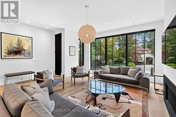 Toronto (Rosedale-Moore Park) apartment for rent - A modern living room with a glass table and grey couches.