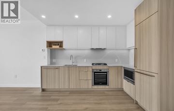 Burnaby apartment for rent - A modern kitchen with wooden cabinets and stainless steel appliances.