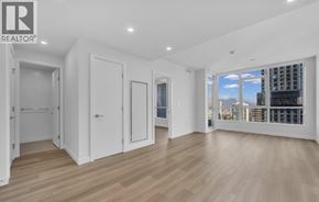 Burnaby apartment for rent - A spacious room with white doors and wooden flooring.