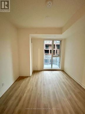 Markham (Unionville) condo for rent - A room with wooden flooring and a large window.