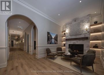 Toronto (Kingsway South) condo for rent - A living room with a fireplace and a painting on the wall.