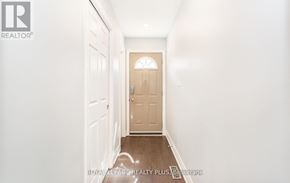 Mississauga (Cooksville) apartment for rent - A hallway with a wooden door at the end.