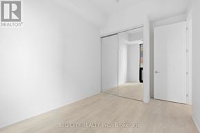 Toronto (Thorncliffe Park) condo for rent - A white room with a sliding door and a wooden floor.