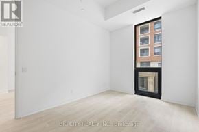 Toronto (Thorncliffe Park) condo for rent - A room with a fireplace and a window showing a building outside.