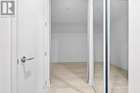 Toronto (Thorncliffe Park) condo for rent - A white door with a handle is open to a room with white walls and wooden flooring.