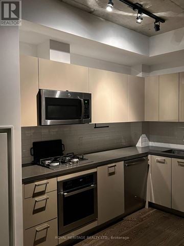 Toronto (Waterfront Communities) condo for rent - A kitchen with a stove top oven and microwave.