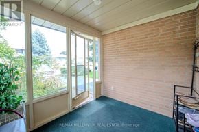 Brampton (Brampton East) apartment for rent - A room with a brick wall and a sliding glass door.