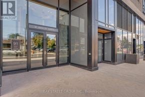 Hamilton (Corktown) condo for rent - The entrance to a building with glass doors and a sign that reads "91 John St North".