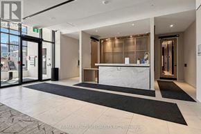 Toronto (Regent Park) condo for rent - The image shows the front desk of a RE/MAX Realty Specialists office with a reception area.