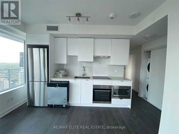 Toronto (Mount Pleasant West) condo for rent - A kitchen with white cabinets and appliances in a modern home.