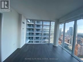 Toronto (Mount Pleasant West) condo for rent - A room with a view of the cityscape through large windows.