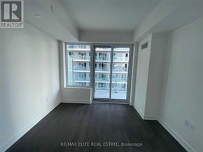 Toronto (Mount Pleasant West) condo for rent - A spacious room with a view of a building through the window.