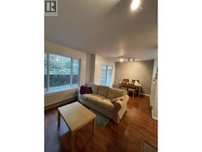 Coquitlam townhouse for rent - A living room with a couch, a coffee table, and a refrigerator.