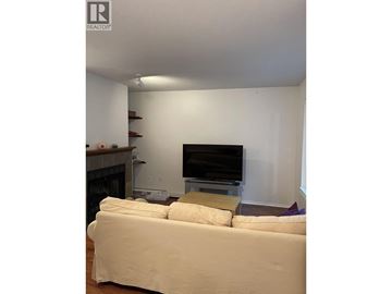 Coquitlam townhouse for rent - A living room with a white couch and a television.