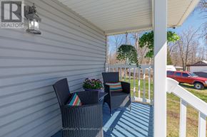 Collingwood apartment for rent - A patio with two chairs and a table with flowers on it.