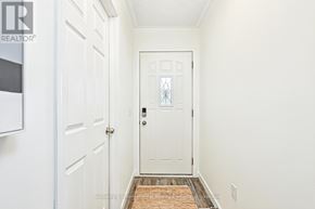 Collingwood apartment for rent - A hallway with a white door and a brown rug.