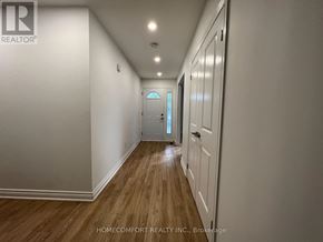Toronto (Morningside) apartment for rent - A long hallway with wooden floors and white walls.