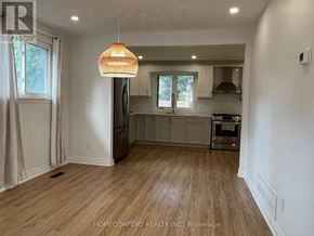 Toronto (Morningside) apartment for rent - A well-lit kitchen with wooden floors and a hanging light fixture.