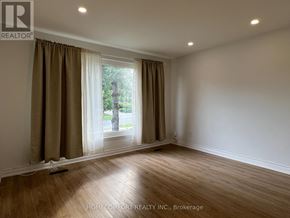 Toronto (Morningside) apartment for rent - A room with a window and curtains, and a wooden floor.