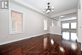 Vaughan (Patterson) townhouse for rent - A room with wooden floors and a chandelier.