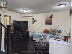 Brampton (Sandringham-Wellington) apartment for rent - A living room with a television, a couch, and a teddy bear.