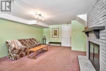 Brampton (Southgate) apartment for rent - A living room with a floral sofa and a fireplace.