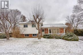 Brampton (Southgate) apartment for rent - A house with a white roof and a snow-covered front yard.