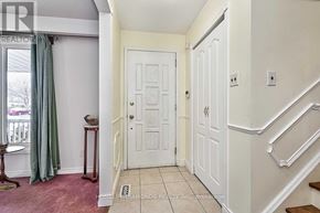 Brampton (Southgate) apartment for rent - A hallway with a white door and a staircase on the right.