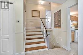 Brampton (Southgate) apartment for rent - A hallway with a staircase and a rug on the floor.