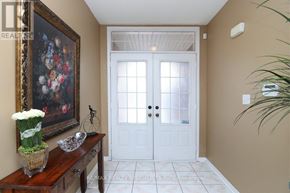 Mississauga (Churchill Meadows) apartment for rent - A white double door with a glass panel is flanked by two windows.