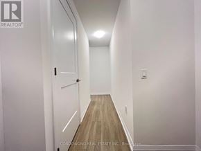 Toronto (Mount Pleasant West) condo for rent - A hallway with a wooden floor and white walls.