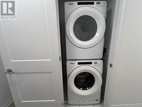Toronto (Mount Pleasant West) condo for rent - A white washer and dryer stacked on top of each other in a small laundry room.