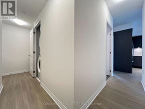 Toronto (Mount Pleasant West) condo for rent - A hallway with a washing machine in the doorway.