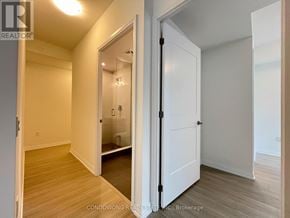 Toronto (Mount Pleasant West) condo for rent - A white door is open to a bathroom with a toilet and sink.