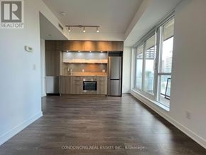 Toronto (Regent Park) condo for rent - A spacious kitchen with wooden cabinets and a large island.