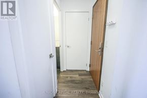 Toronto (Henry Farm) condo for rent - A hallway with a door on the right and a white door on the left.