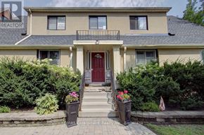Burlington (Brant) multi-family for rent - A house with a red door and a balcony with a railing.